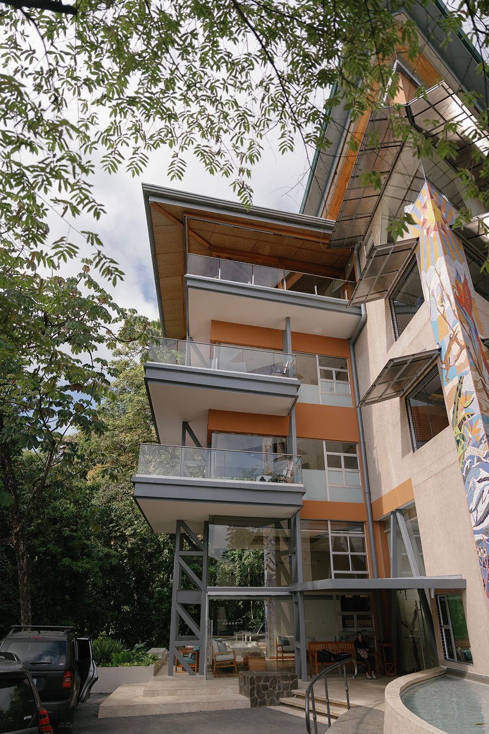 Exterior of Villa Punto de Vista in Manuel Antonio, with glass balconies and modern architecture surrounded by rainforest.