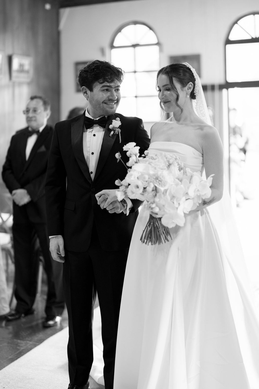 Bride and groom sharing a smile during their church wedding ceremony in Monteverde
