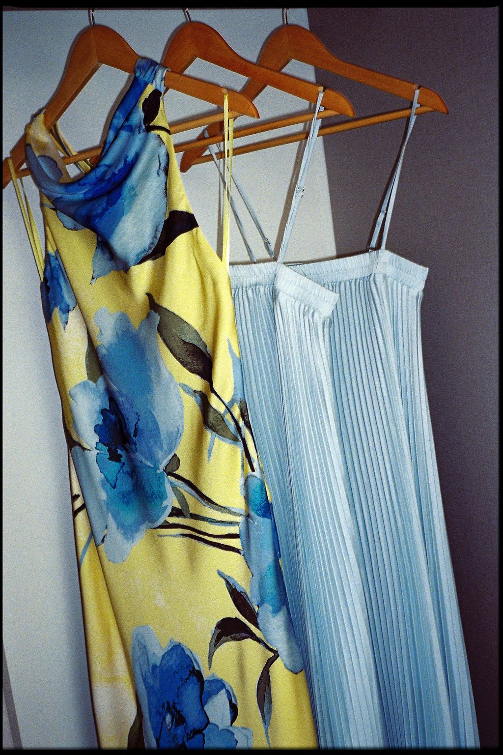 Colorful wedding party dresses hanging together before the celebration