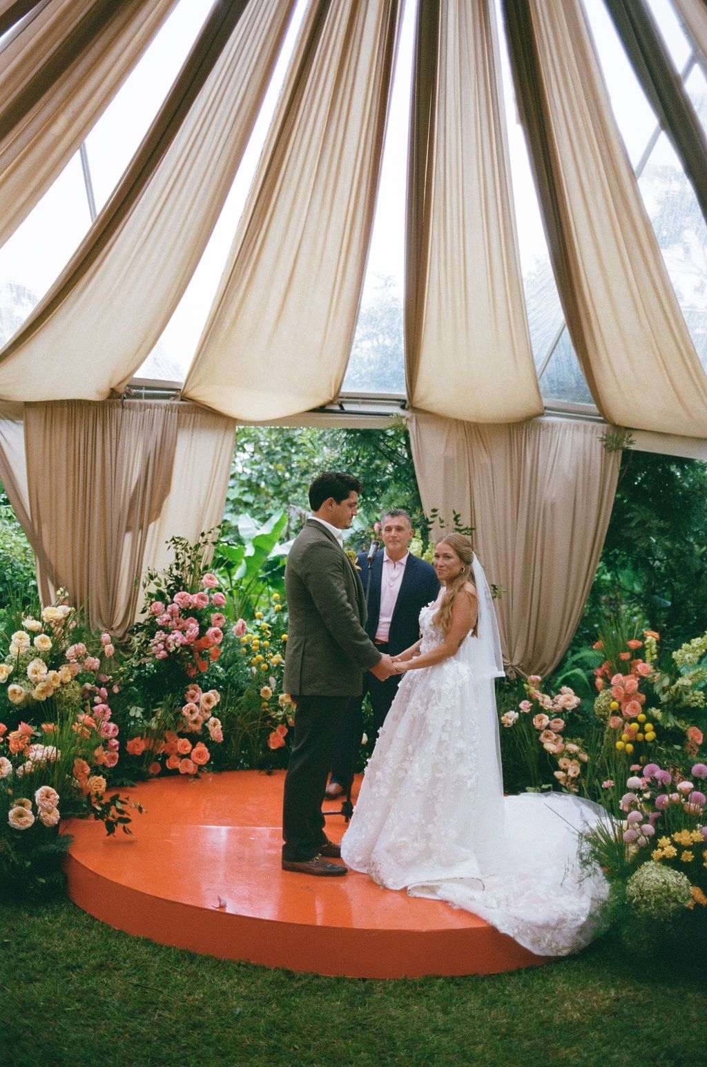 Maureen and Major holding hands during their rainforest wedding ceremony in Costa Rica, photographed on film