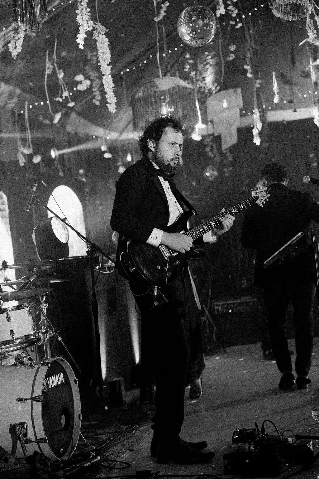 Guitarist performing with a live band during Maureen and Major's wedding reception in Costa Rica