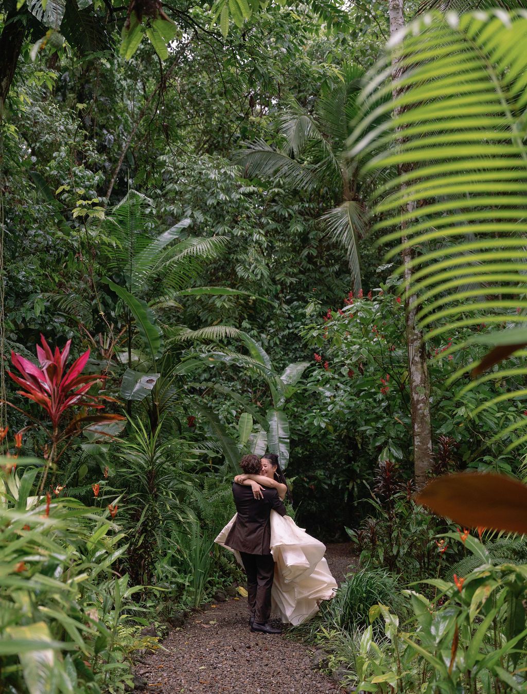 Newlyweds embracing on a rainforest path after their Golfo Dulce elopement