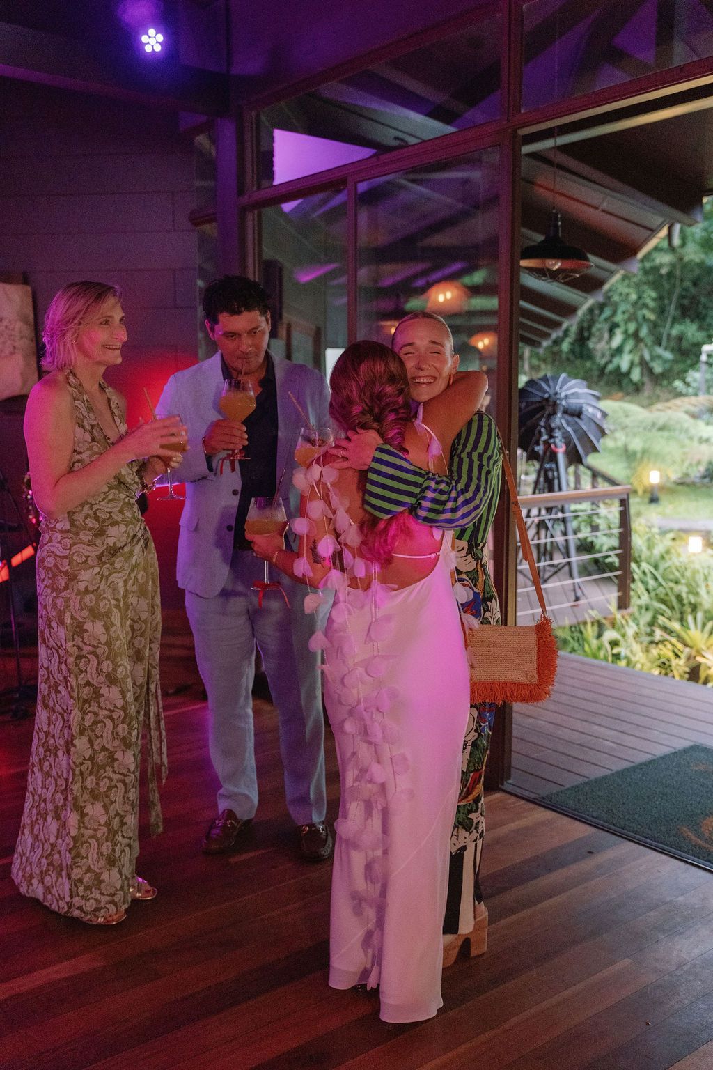 Guests embracing during a destination wedding welcome party in Costa Rica