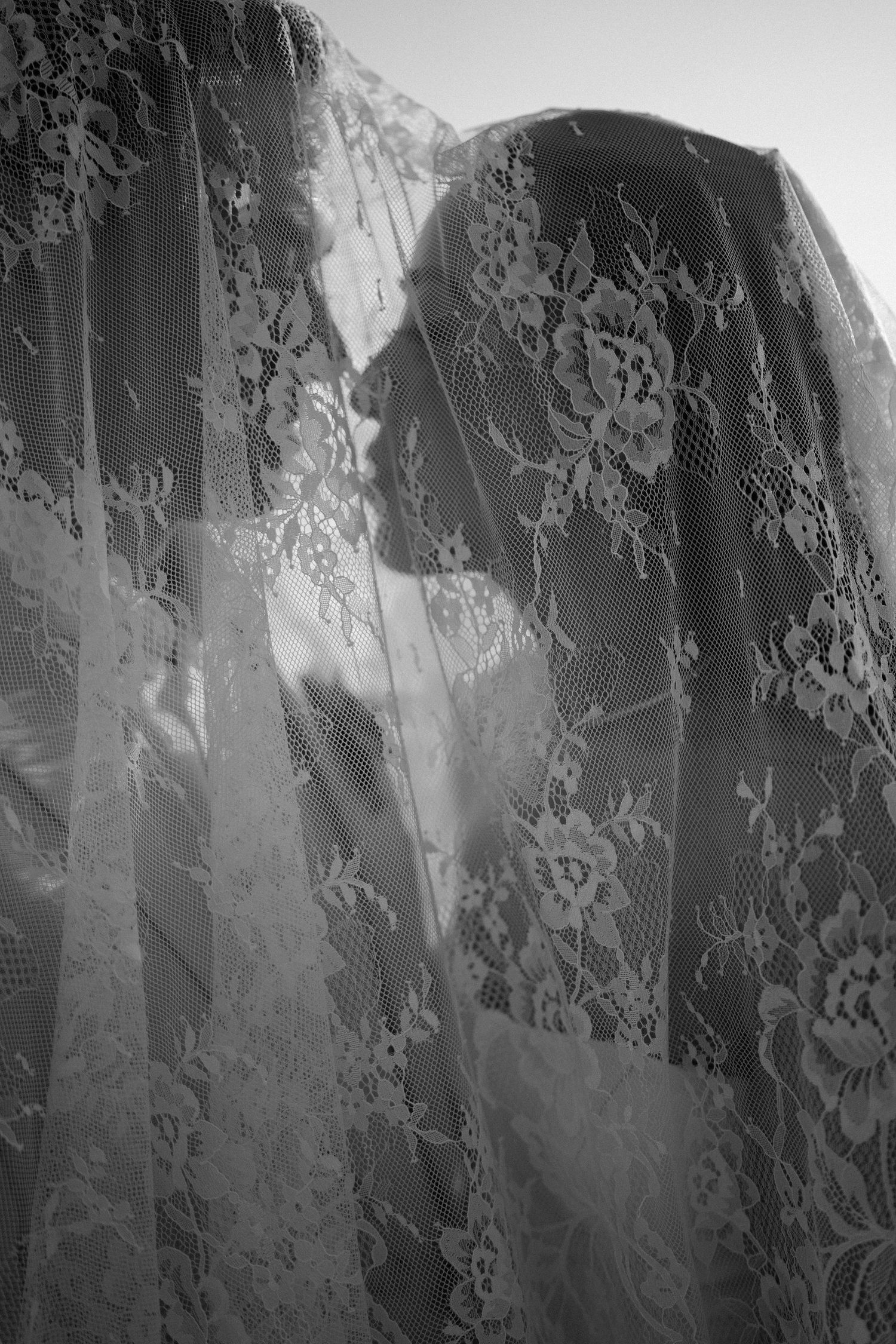 Black and white close-up of Ashley beneath her lace wedding veil