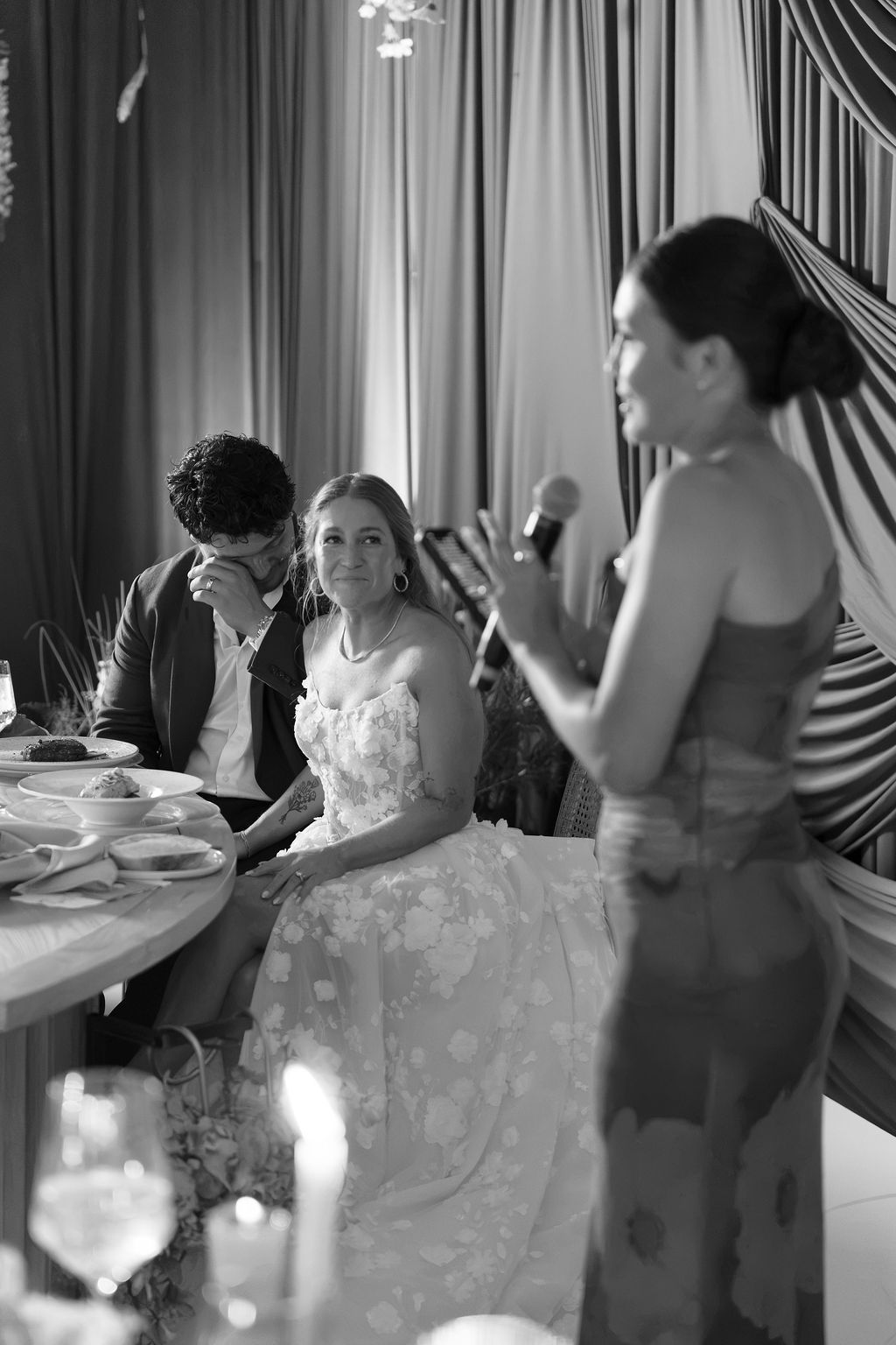 Maureen and Major listening to an emotional speech during their rainforest wedding reception in Costa Rica