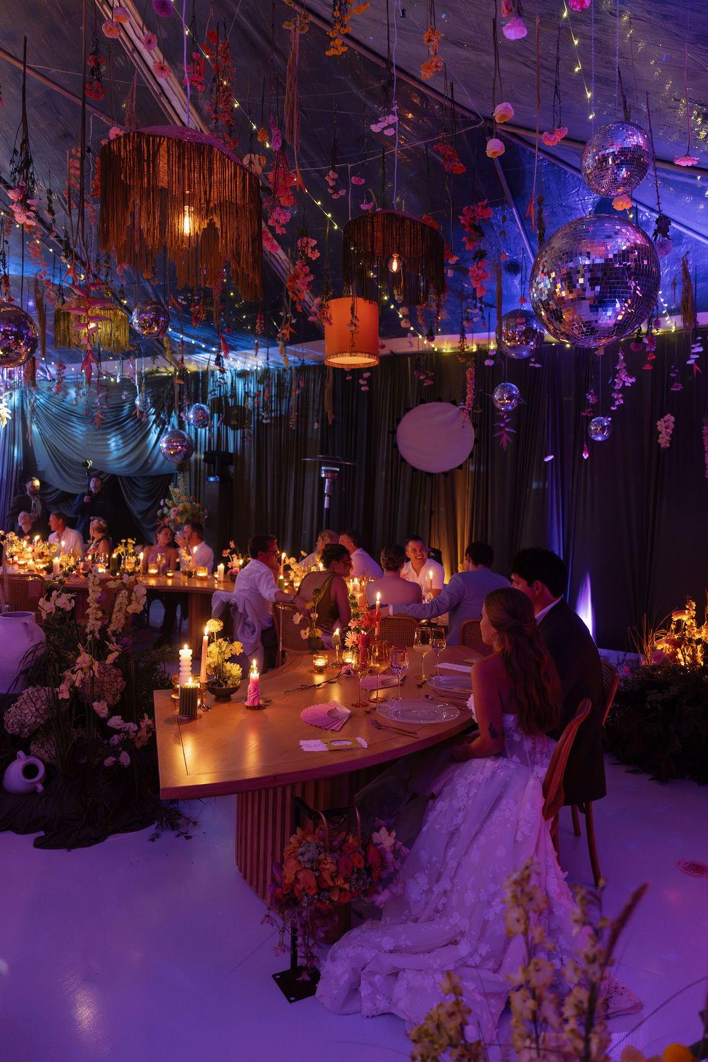 Colorful wedding reception with flowers, candlelight and disco balls in Costa Rica.