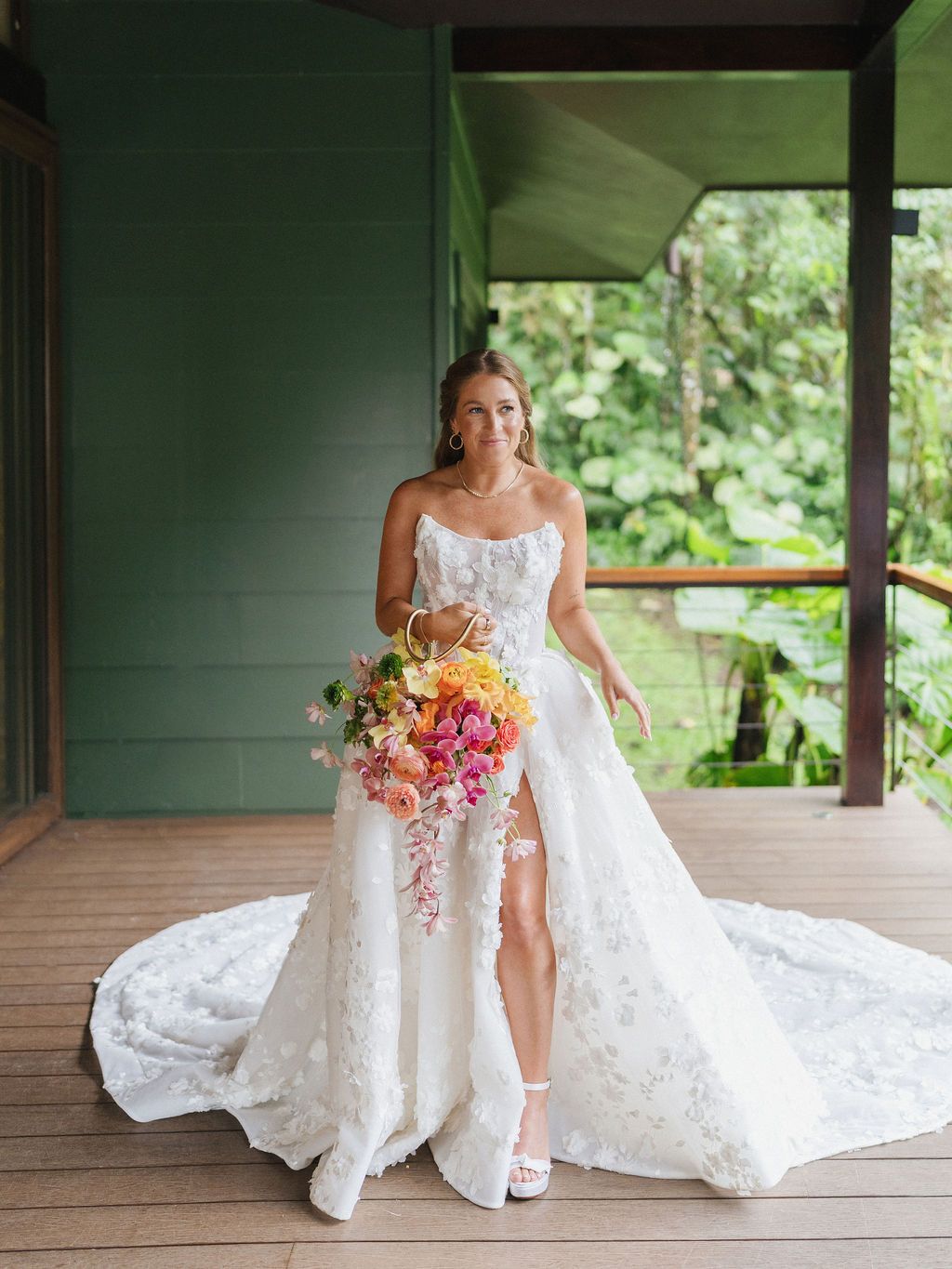 Bride holding a colorful tropical bouquet before her rainforest wedding in Costa Rica