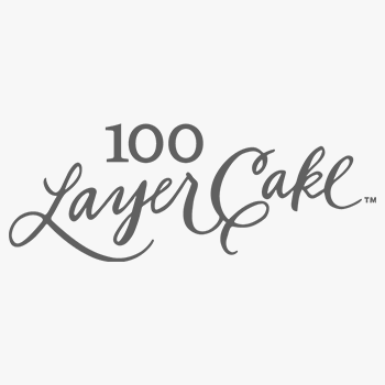 100 Layer Cake logo in elegant gray script typography on white background.