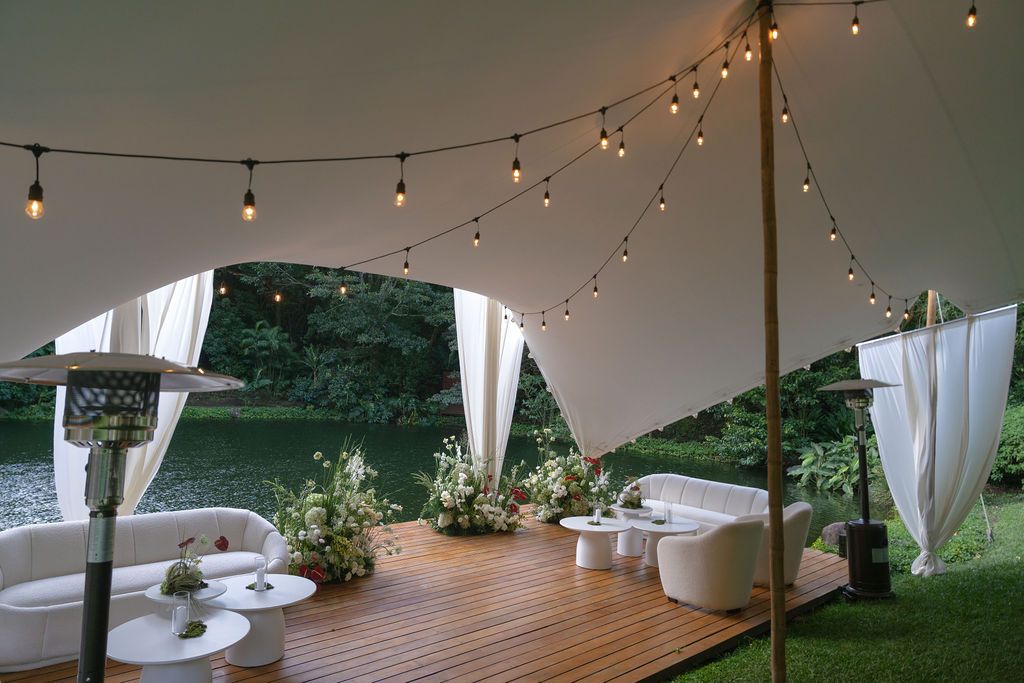 Elegant white wedding lounge with floral arrangements overlooking the forest in Monteverde