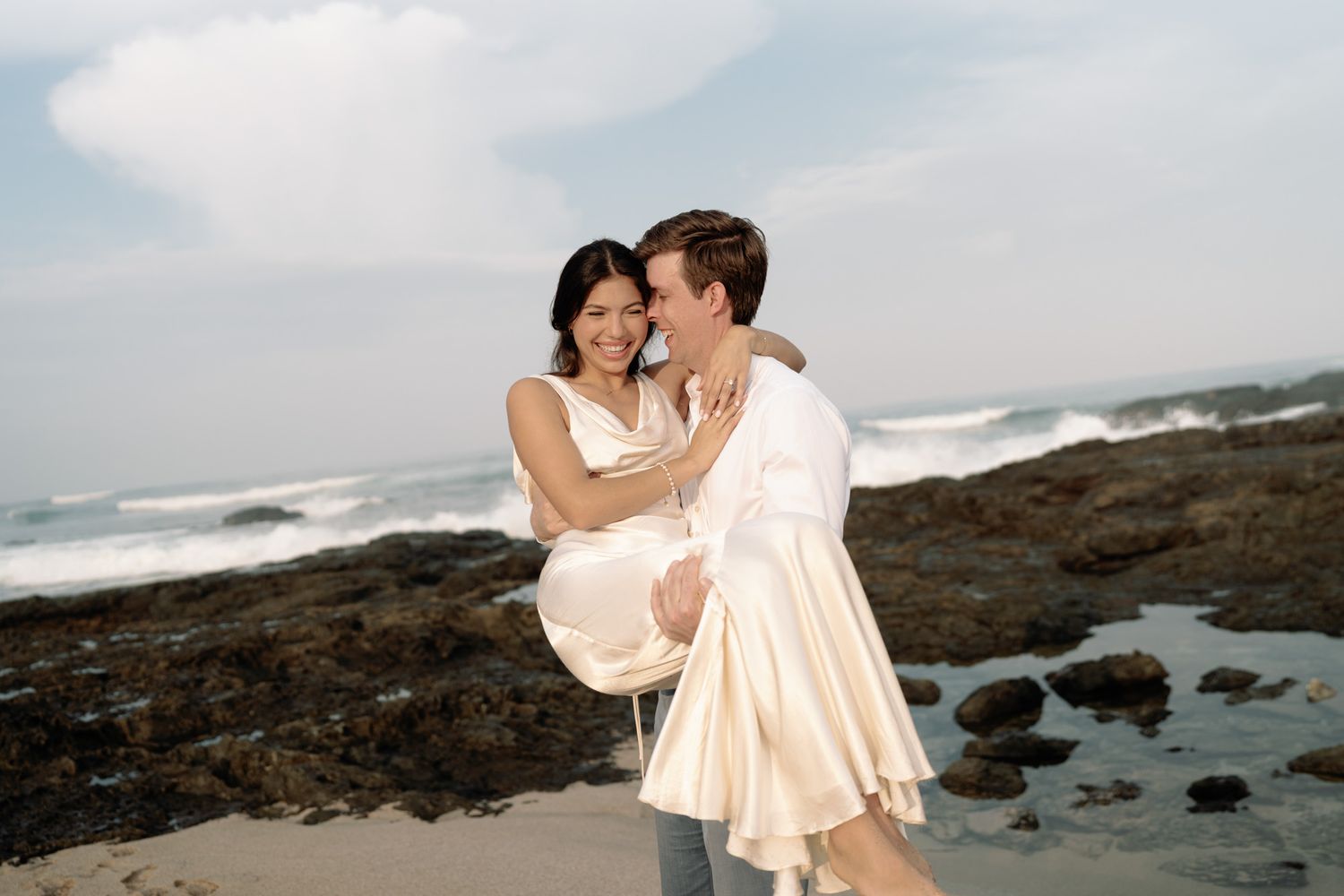 Wedding couple laughing together on the beach in Costa Rica.