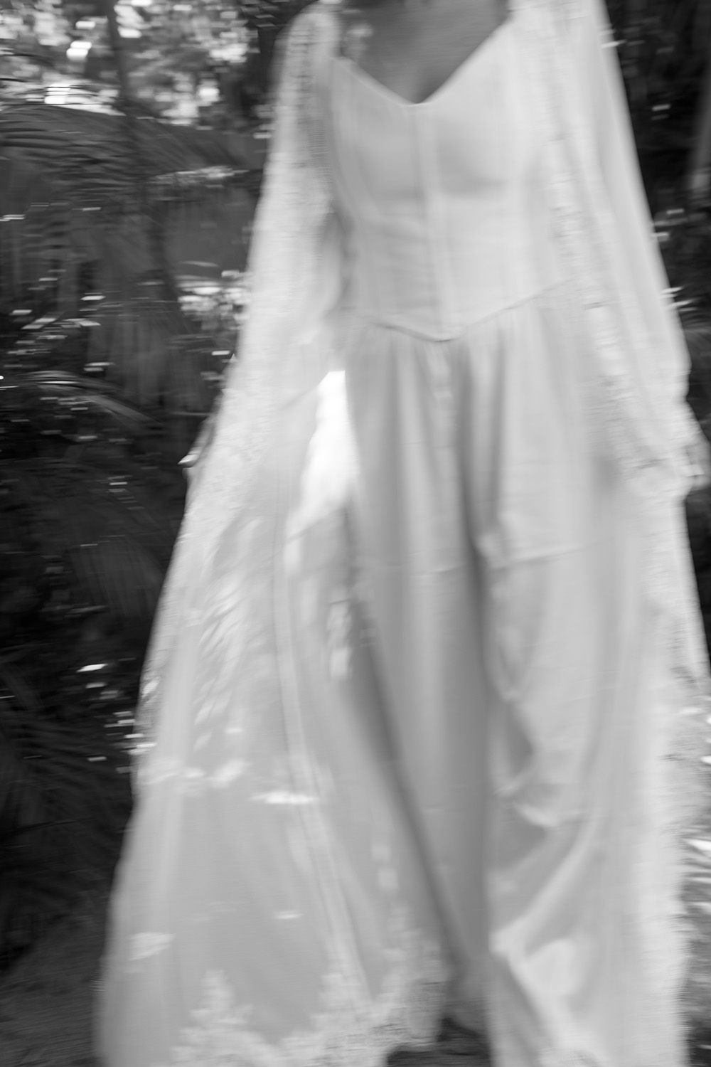 Artistic black and white photograph of a wedding dress surrounded by tropical scenery in Costa Rica.