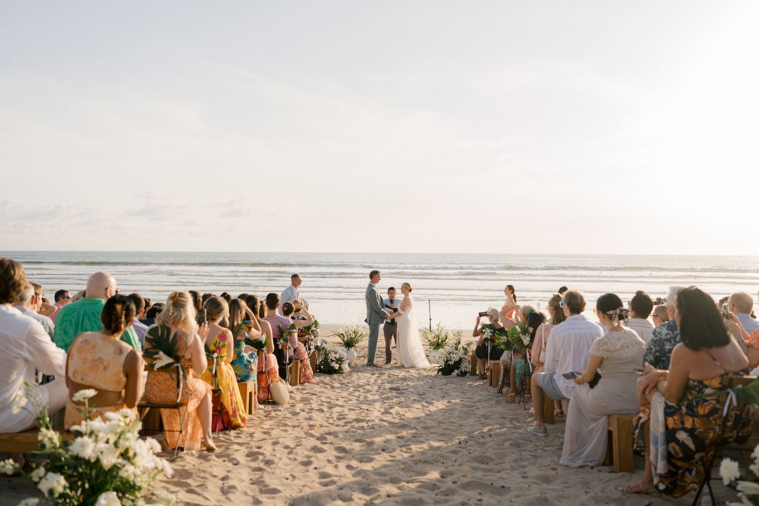 Destination wedding ceremony taking place on a tropical beach in Costa Rica.