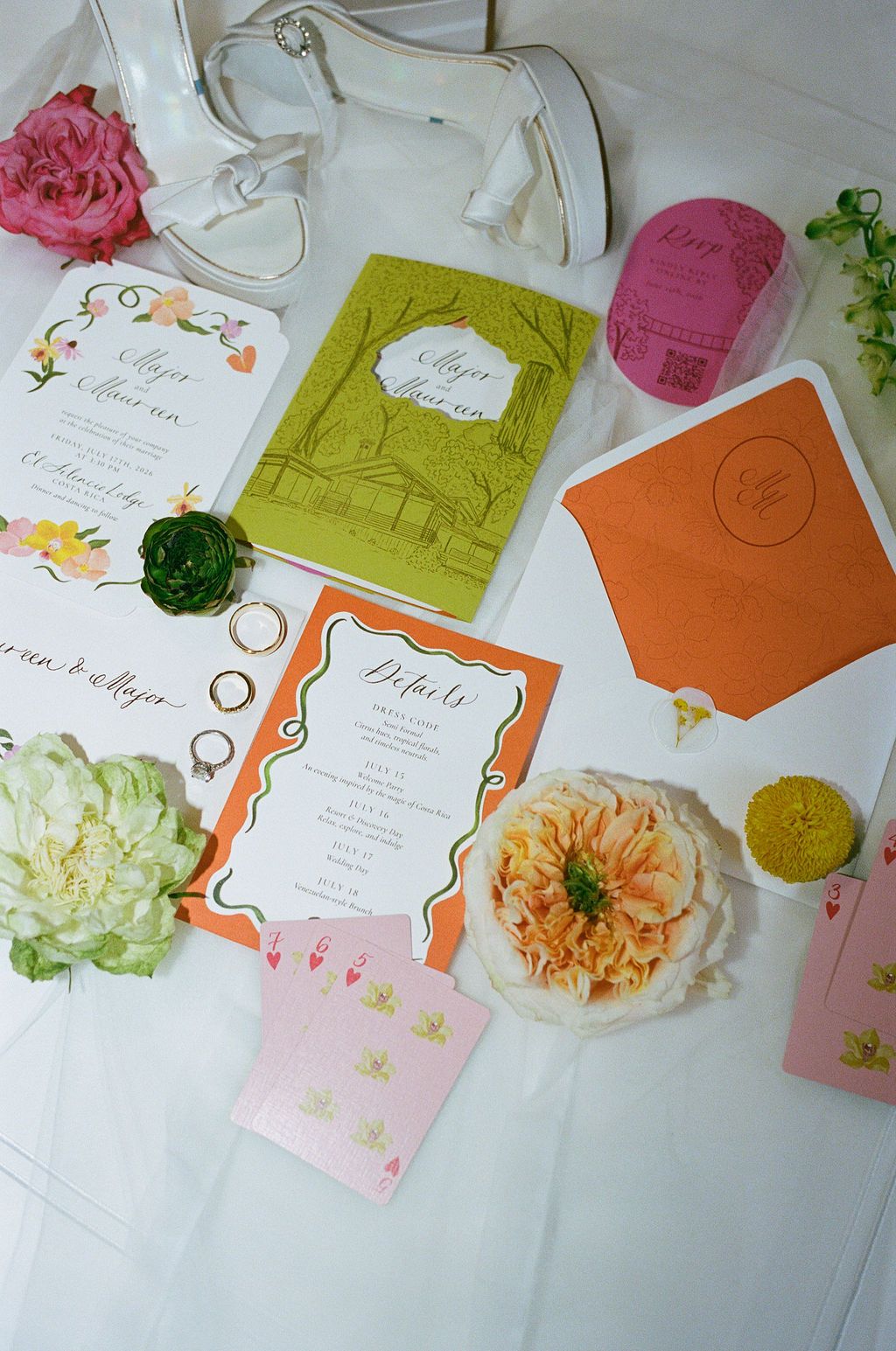 Colorful wedding invitation suite with rings, flowers and bridal shoes photographed in Costa Rica