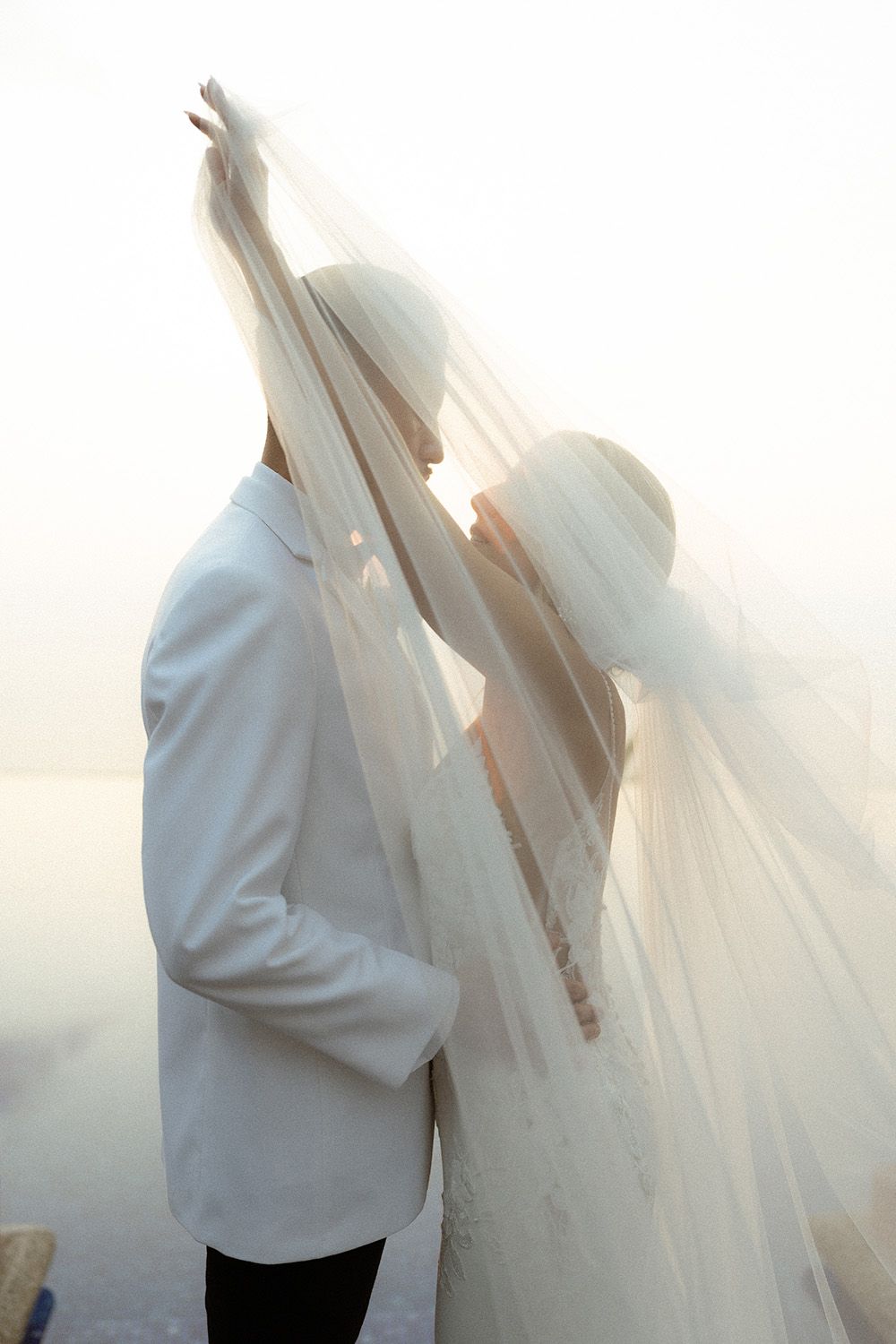 Bride and groom sharing a quiet moment beneath her veil during their Costa Rica wedding