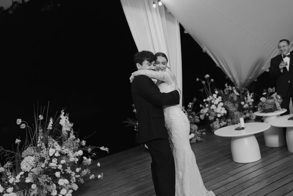 Newlyweds embracing during their intimate outdoor wedding reception in Monteverde