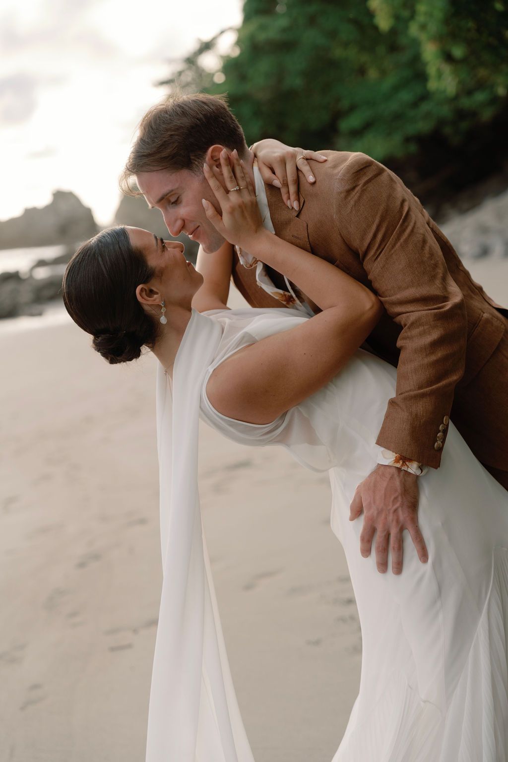 Playful portrait of the newlyweds during their beach session in Manuel Antonio.