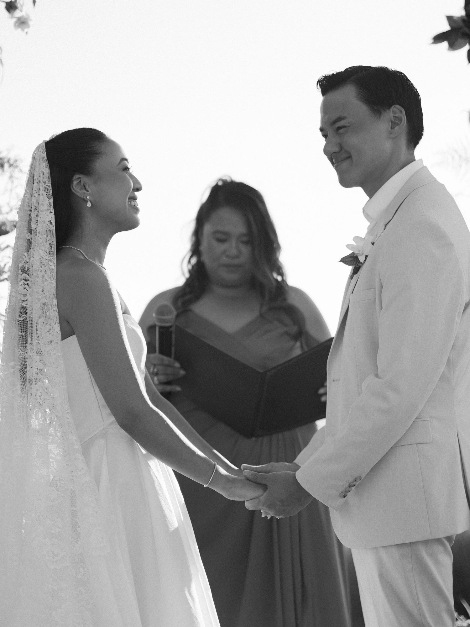 Ashley and Ryan holding hands during their outdoor wedding ceremony at Hacienda Pinilla