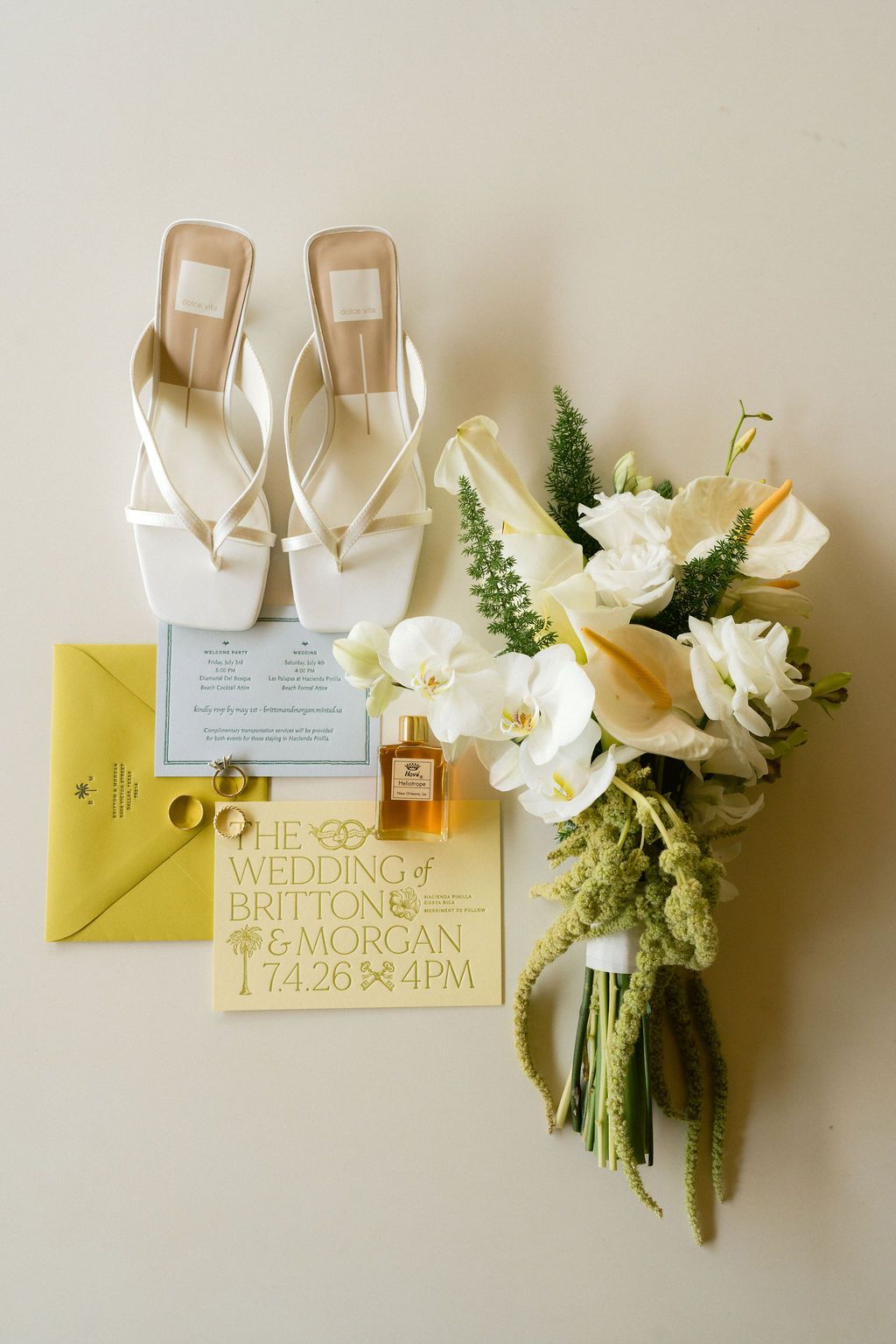Wedding invitation, bridal shoes, rings and tropical bouquet from Morgan and Britton’s wedding