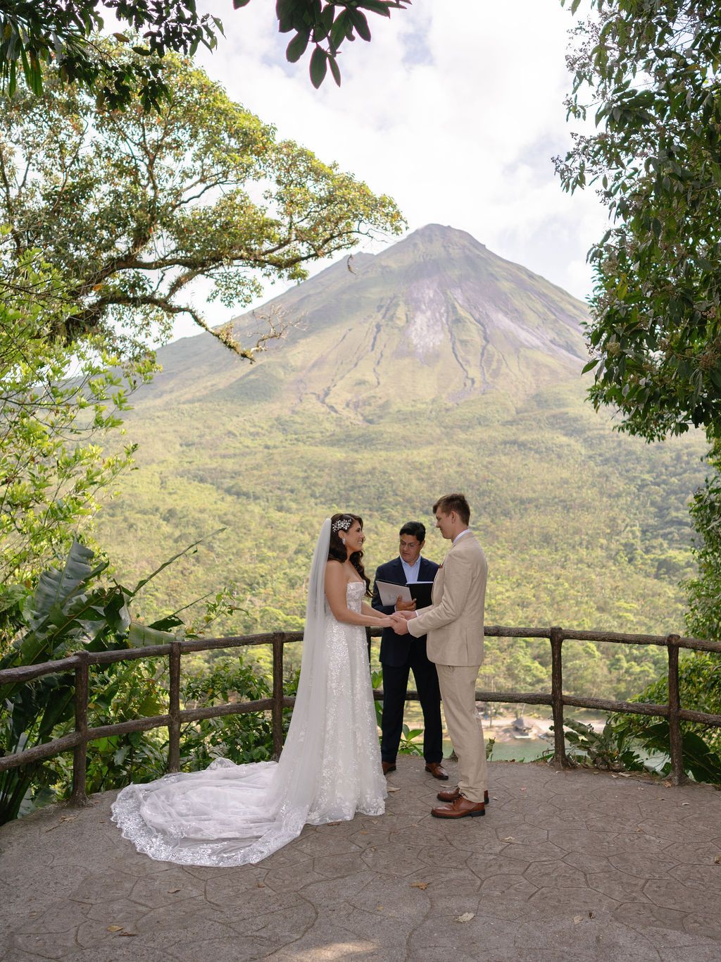 Couple exchanging vows during their Arenal Volcano elopement in La Fortuna