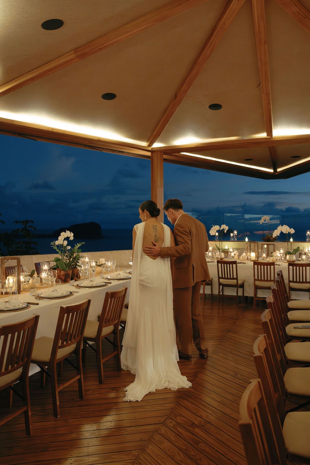 Newlyweds entering their candlelit wedding dinner overlooking the Pacific at Villa Punto de Vista.