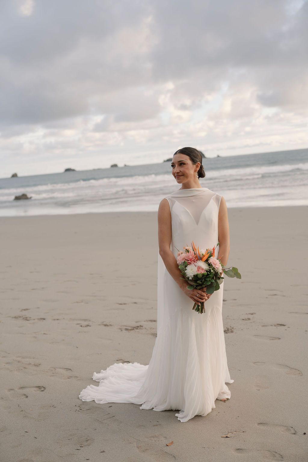 Bride holding a tropical bouquet during a portrait session on the beach in Manuel Antonio.