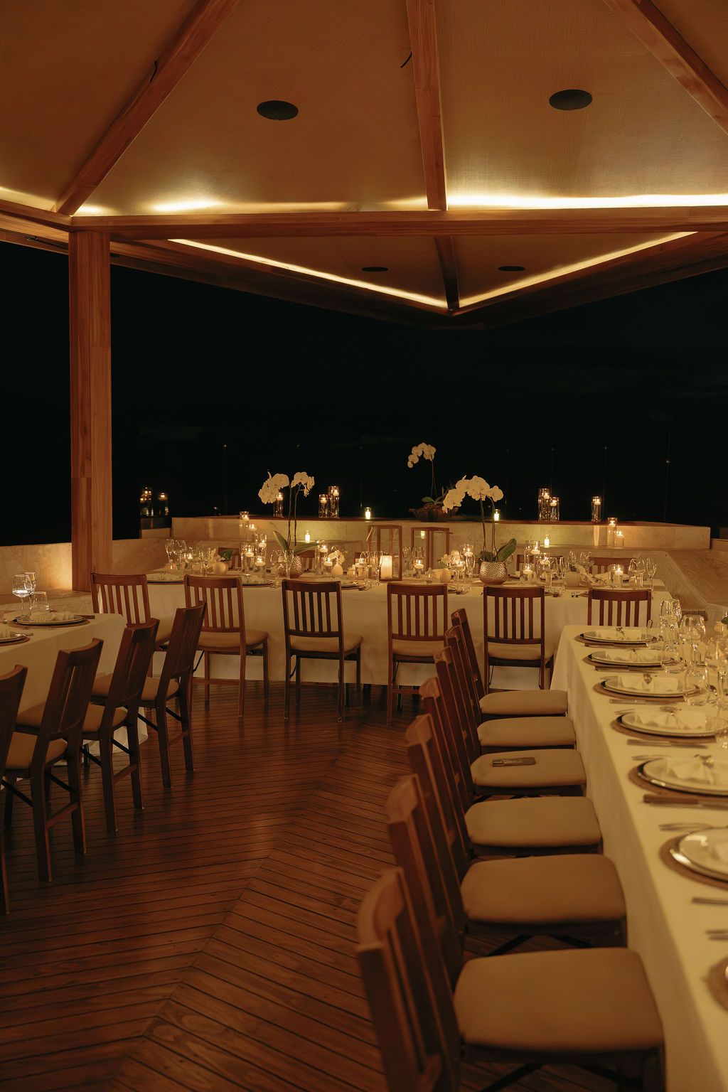 Elegant candlelit dinner table with orchids overlooking the coast in Manuel Antonio.