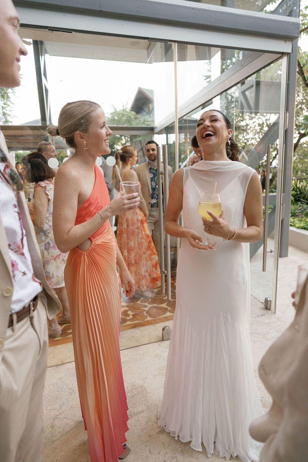 Bride laughing with a guest during her intimate wedding celebration in Manuel Antonio.