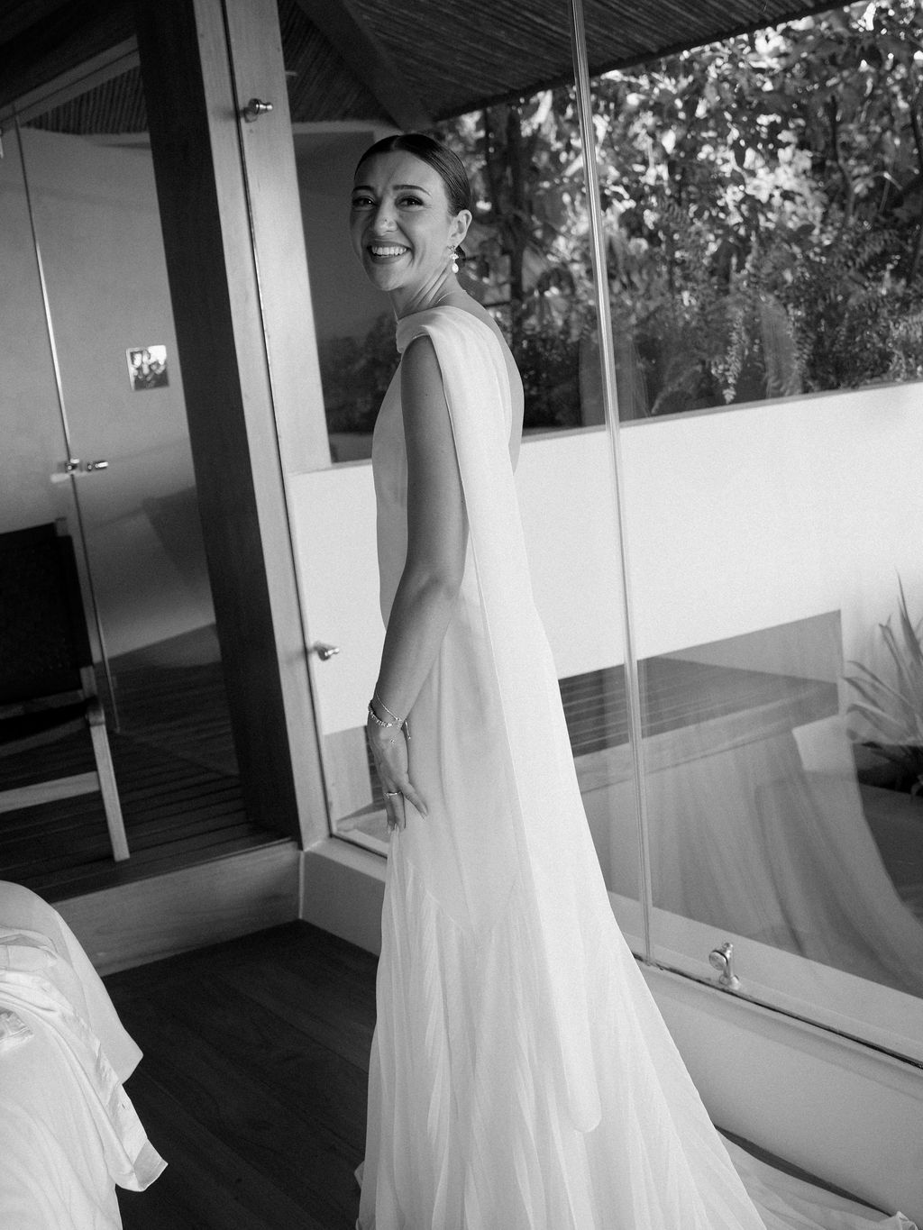 Candid black-and-white portrait of the bride smiling before the celebration.