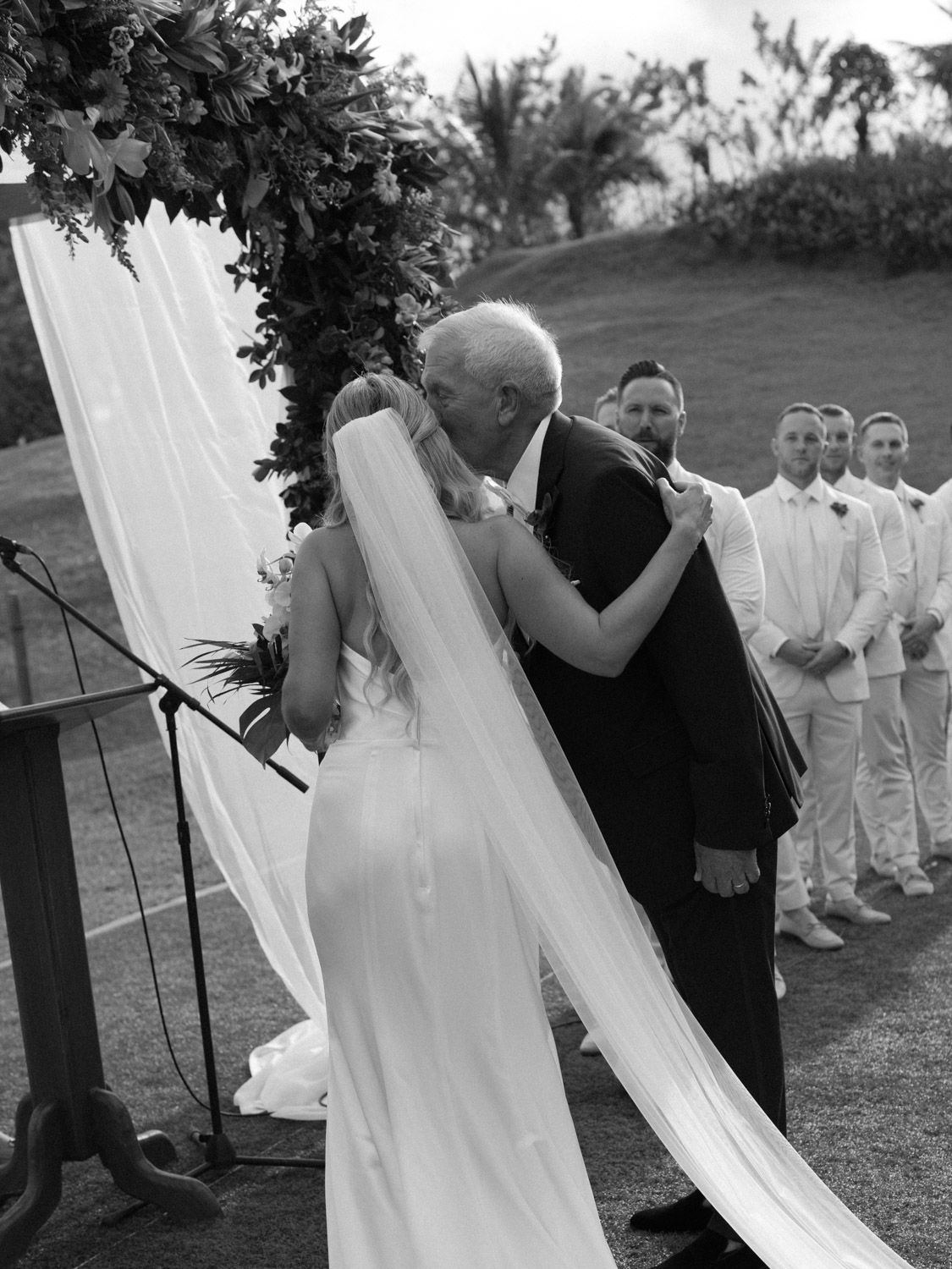 Black and white photo of a bride and her father sharing an emotional moment