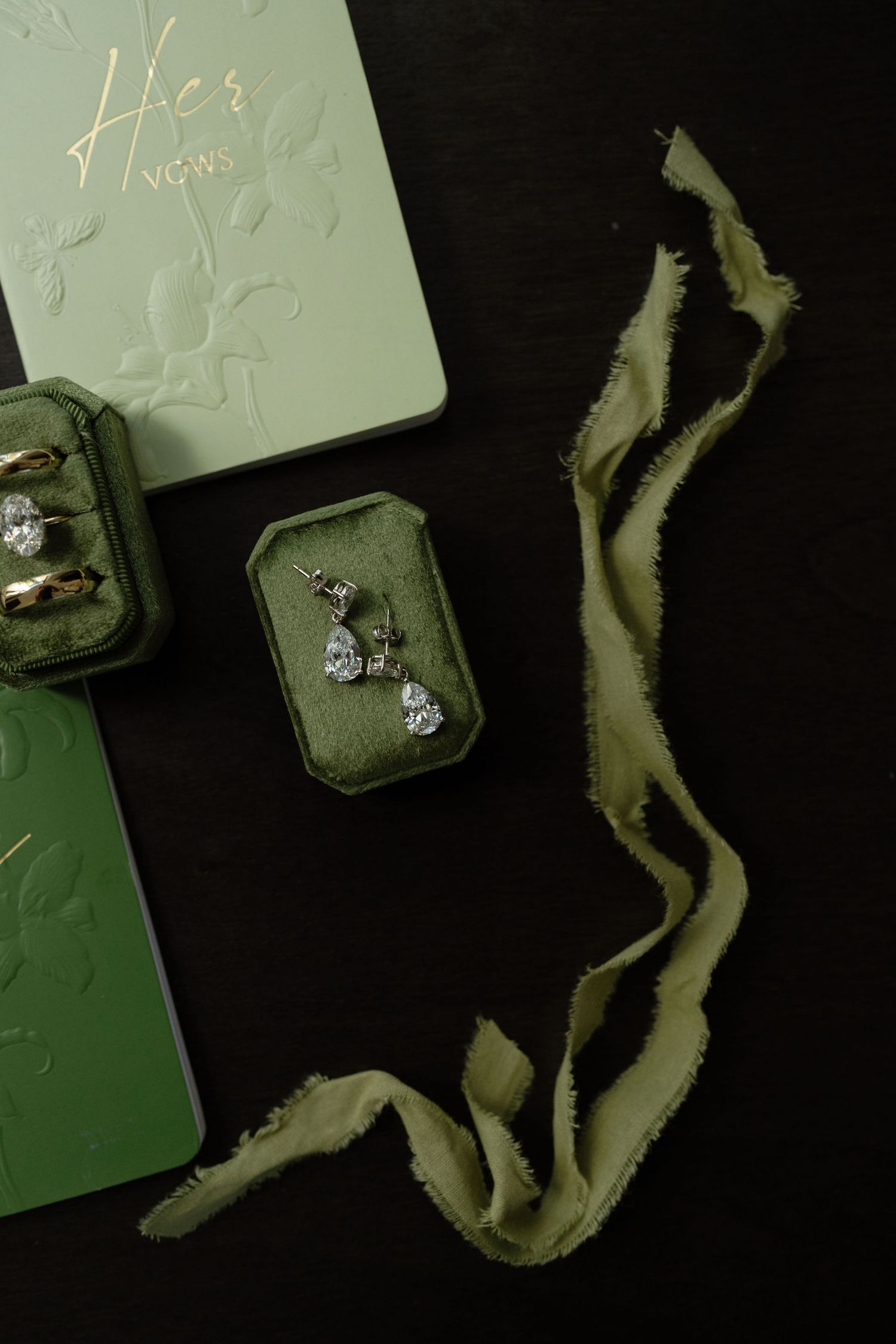 Wedding rings and bridal earrings photographed before a Hacienda Pinilla wedding in Costa Rica