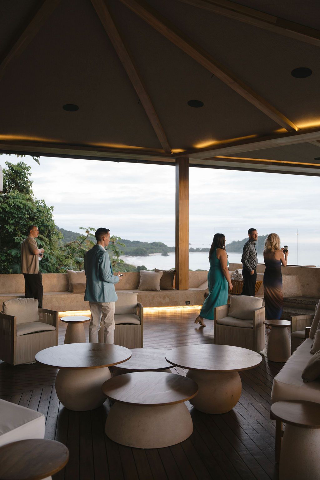 Guests gathering on the terrace at Villa Punto de Vista with the Manuel Antonio coastline in the background.