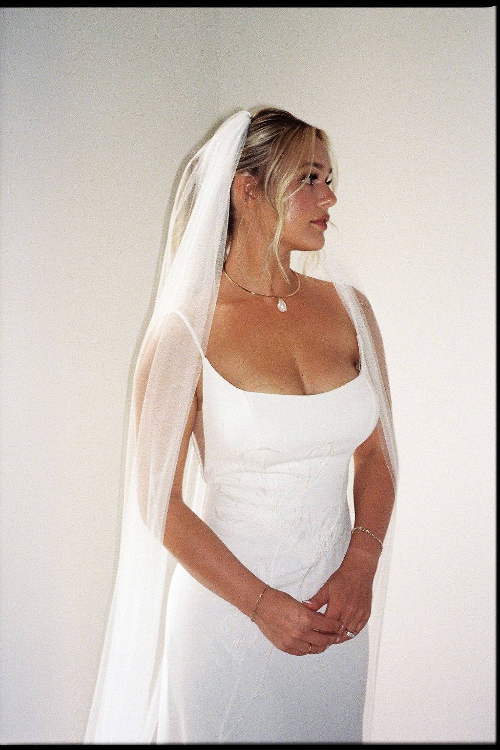 Bride in her wedding dress and veil photographed on film before the ceremony