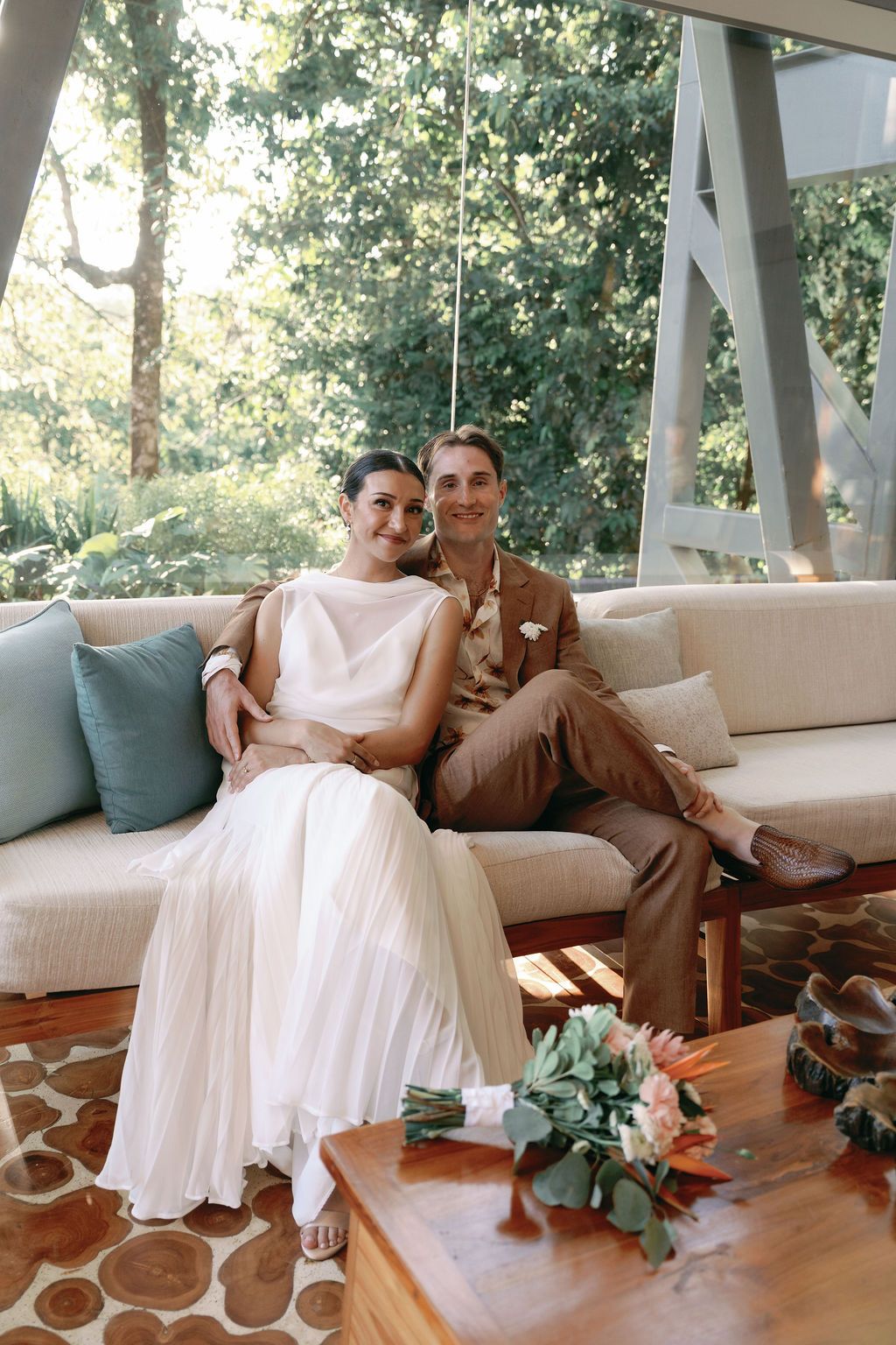 Newlyweds seated together inside Villa Punto de Vista after their intimate celebration.