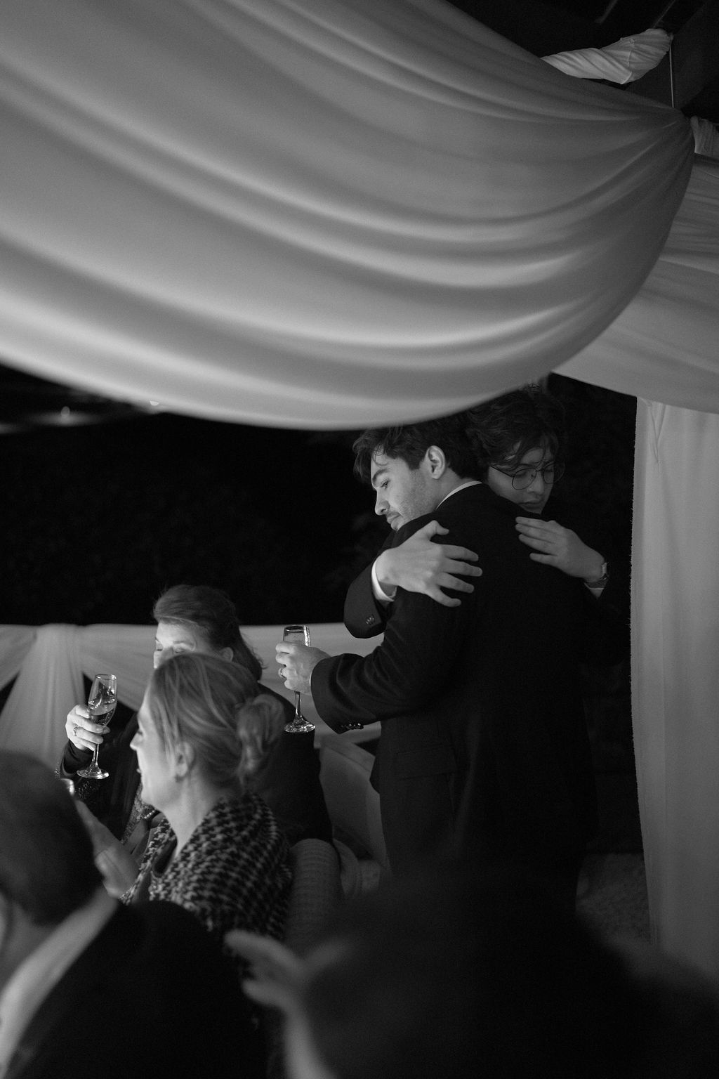 Black and white candid moment of the newlyweds embracing during their Monteverde wedding reception