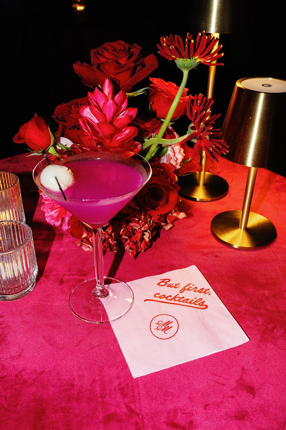 Colorful wedding cocktail surrounded by red and pink floral details at a Costa Rica reception.