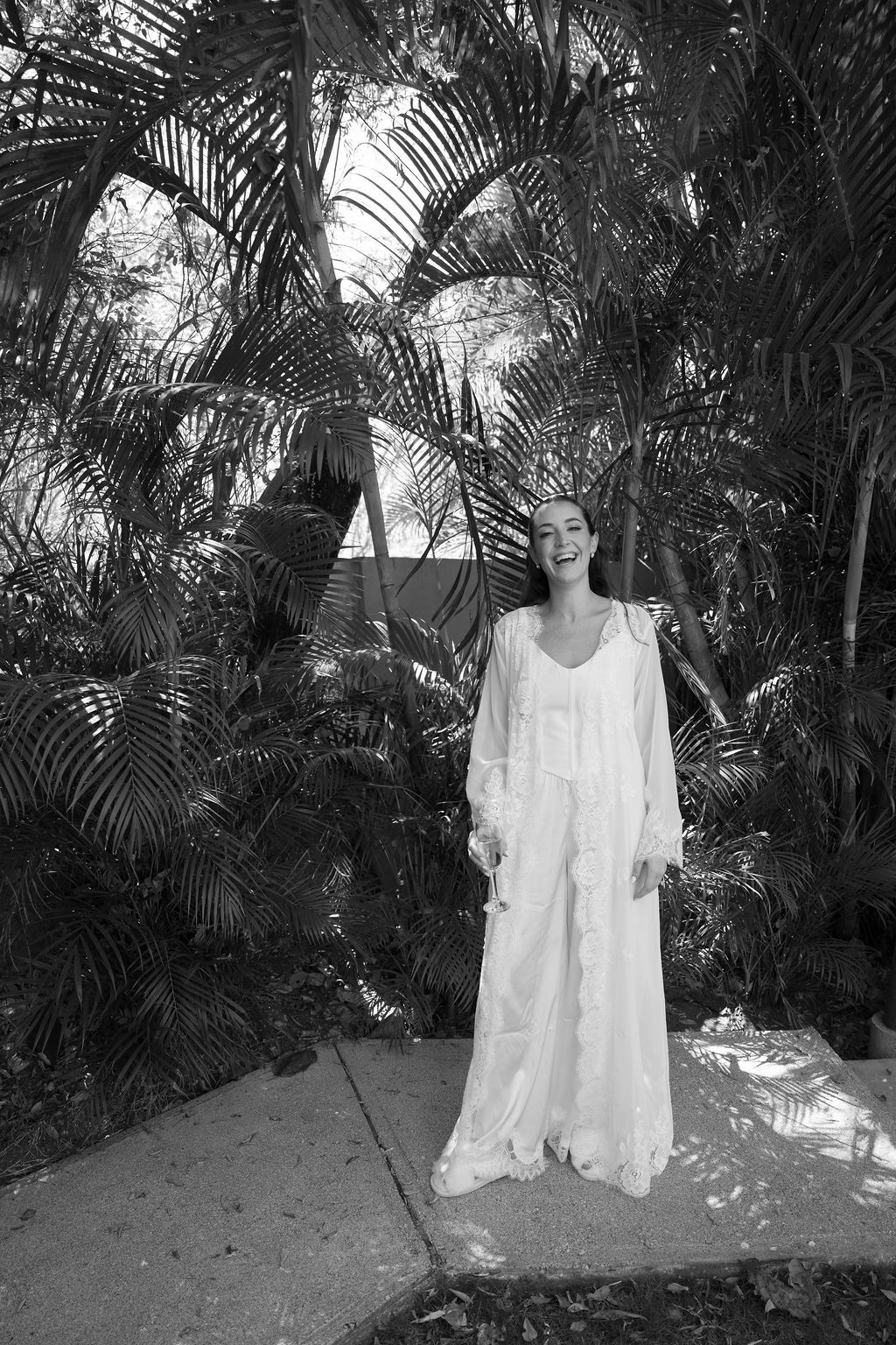 Bride laughing during a candid moment before her wedding in Costa Rica.