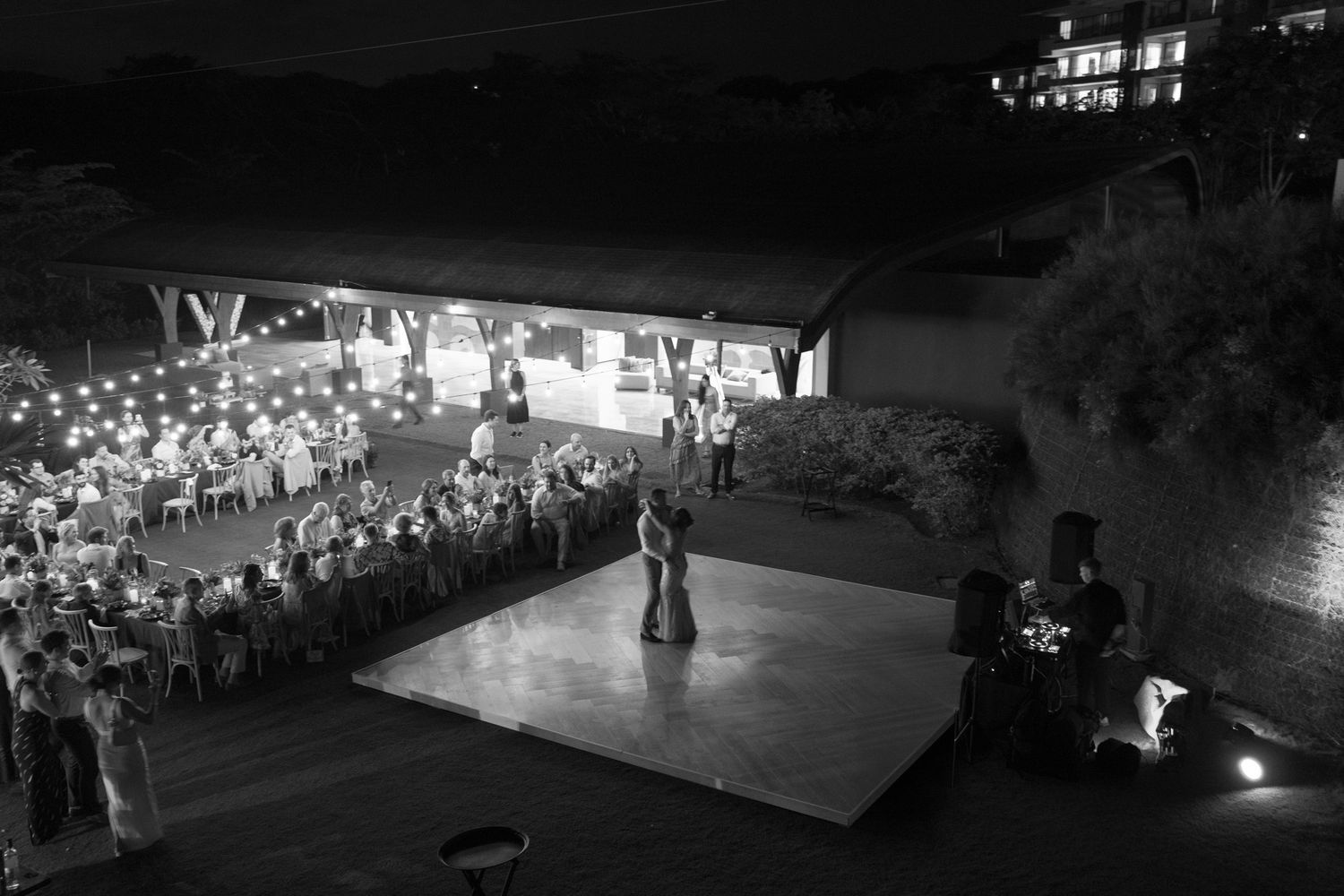 Couple sharing their first dance during an outdoor wedding reception in Costa Rica.