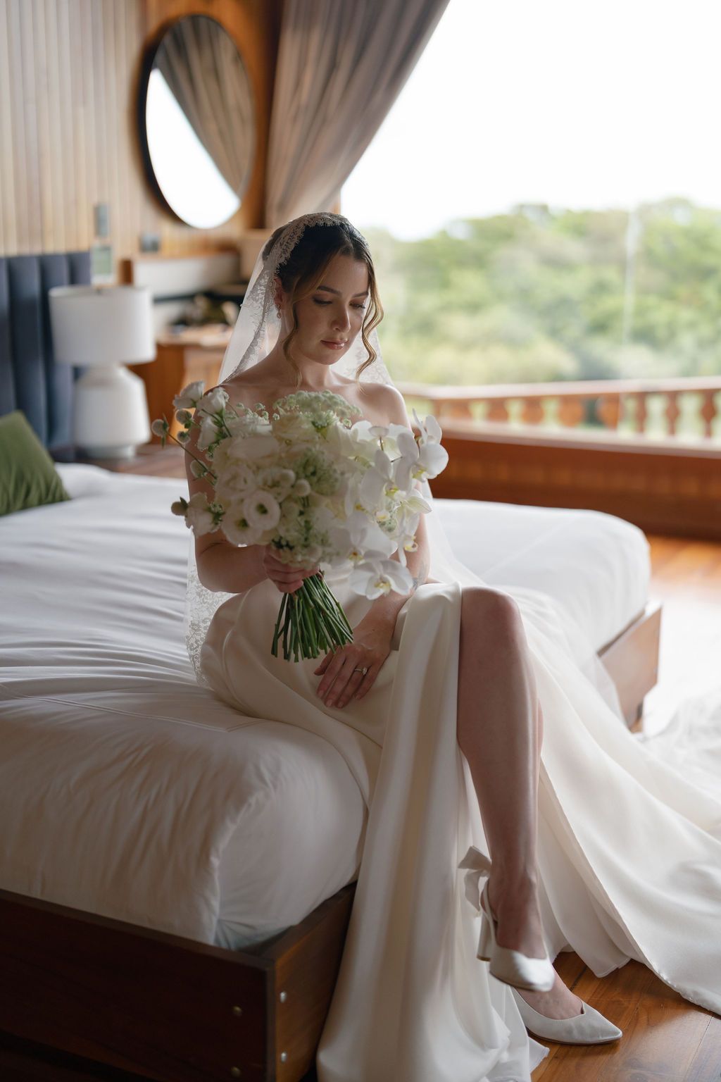 Bride holding a white floral bouquet while getting ready for her wedding in Costa Rica.