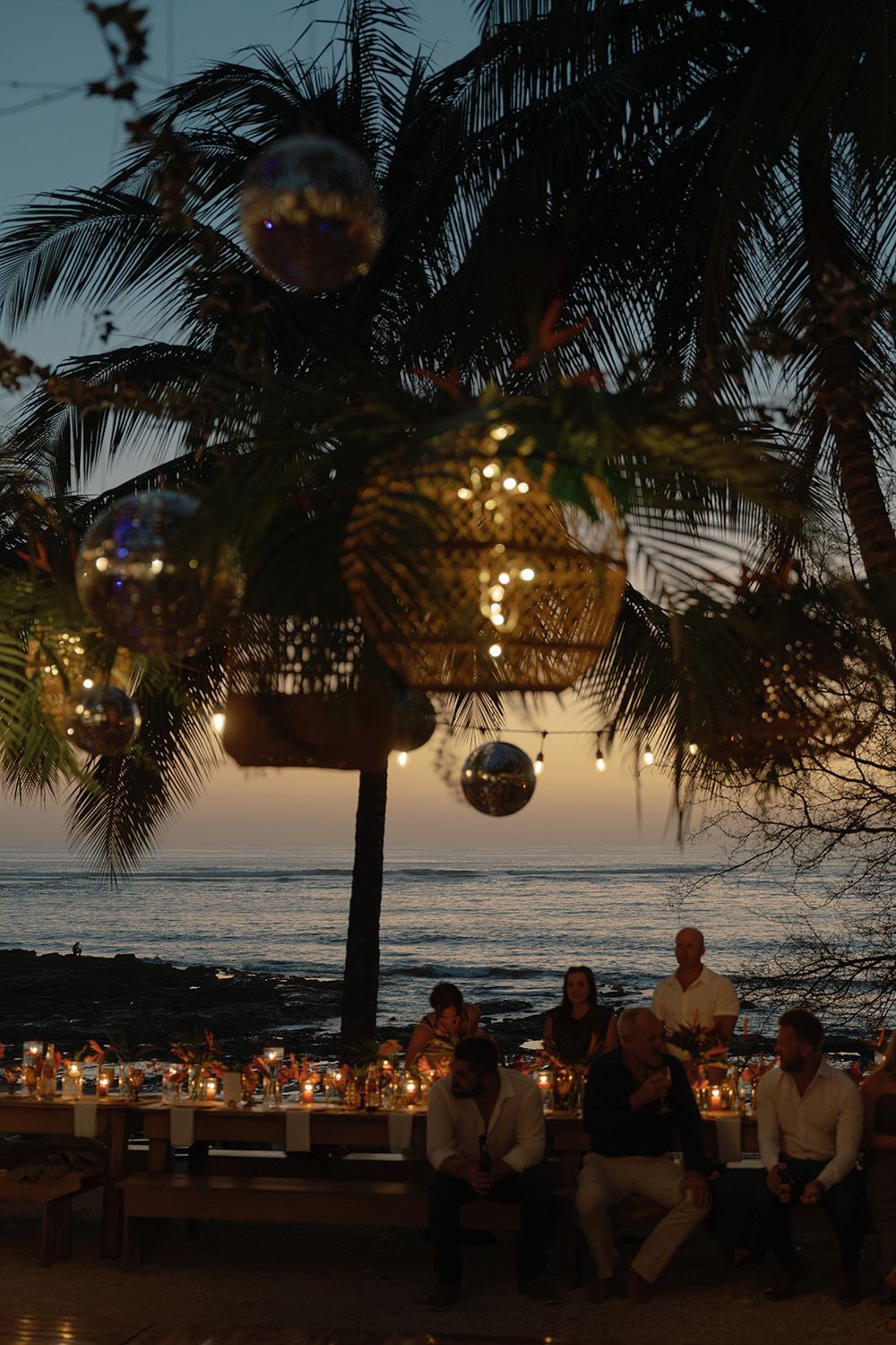 Outdoor wedding reception overlooking the Pacific Ocean at sunset in Costa Rica.