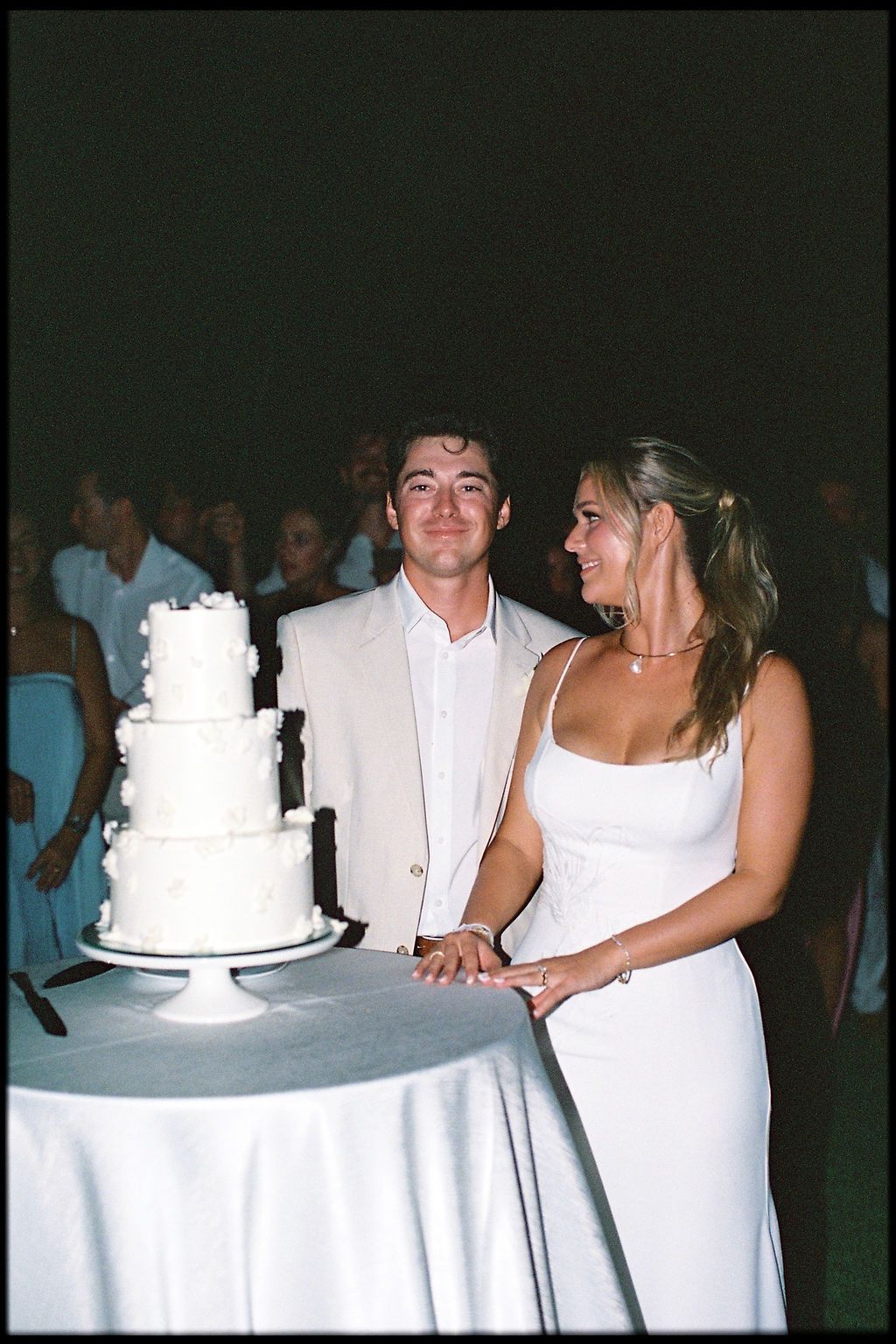 Morgan and Britton beside their wedding cake during the evening reception
