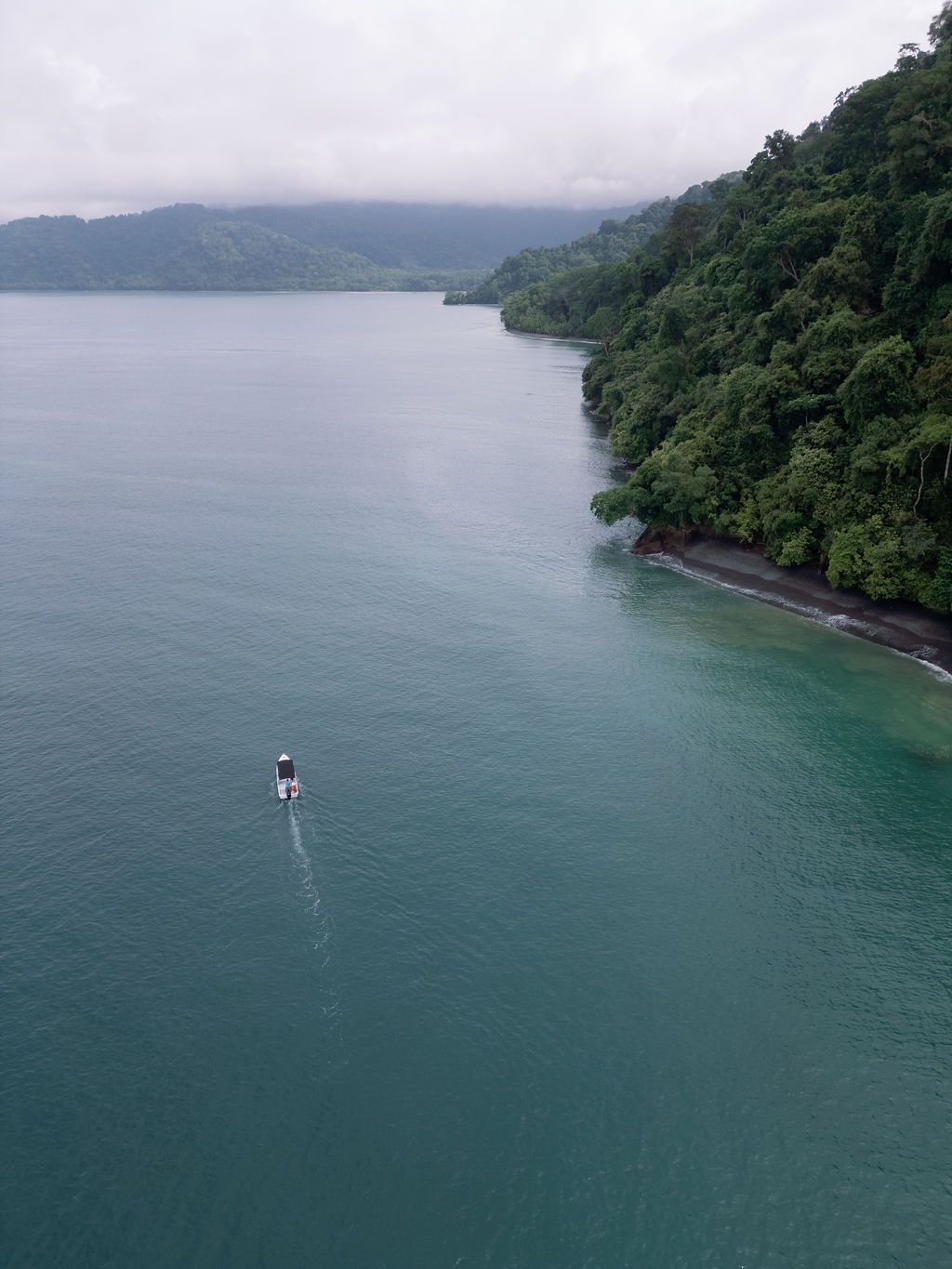 Boat approaching the remote rainforest coastline of Golfo Dulce, Costa Rica