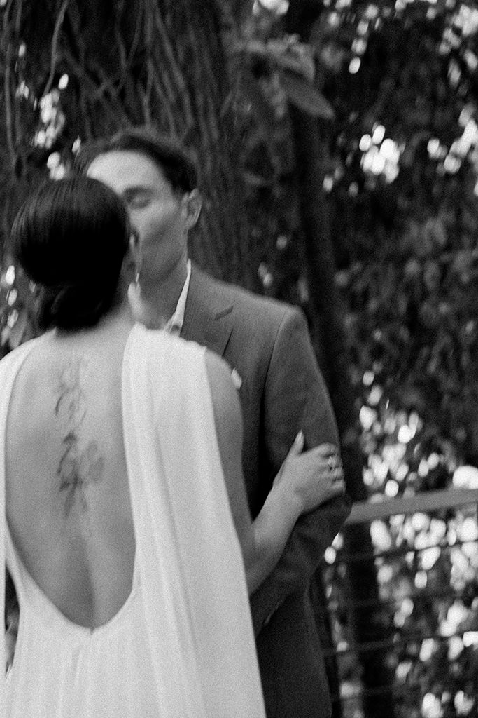Black and white candid portrait of a newlywed couple sharing an intimate moment during their Costa Rica wedding.