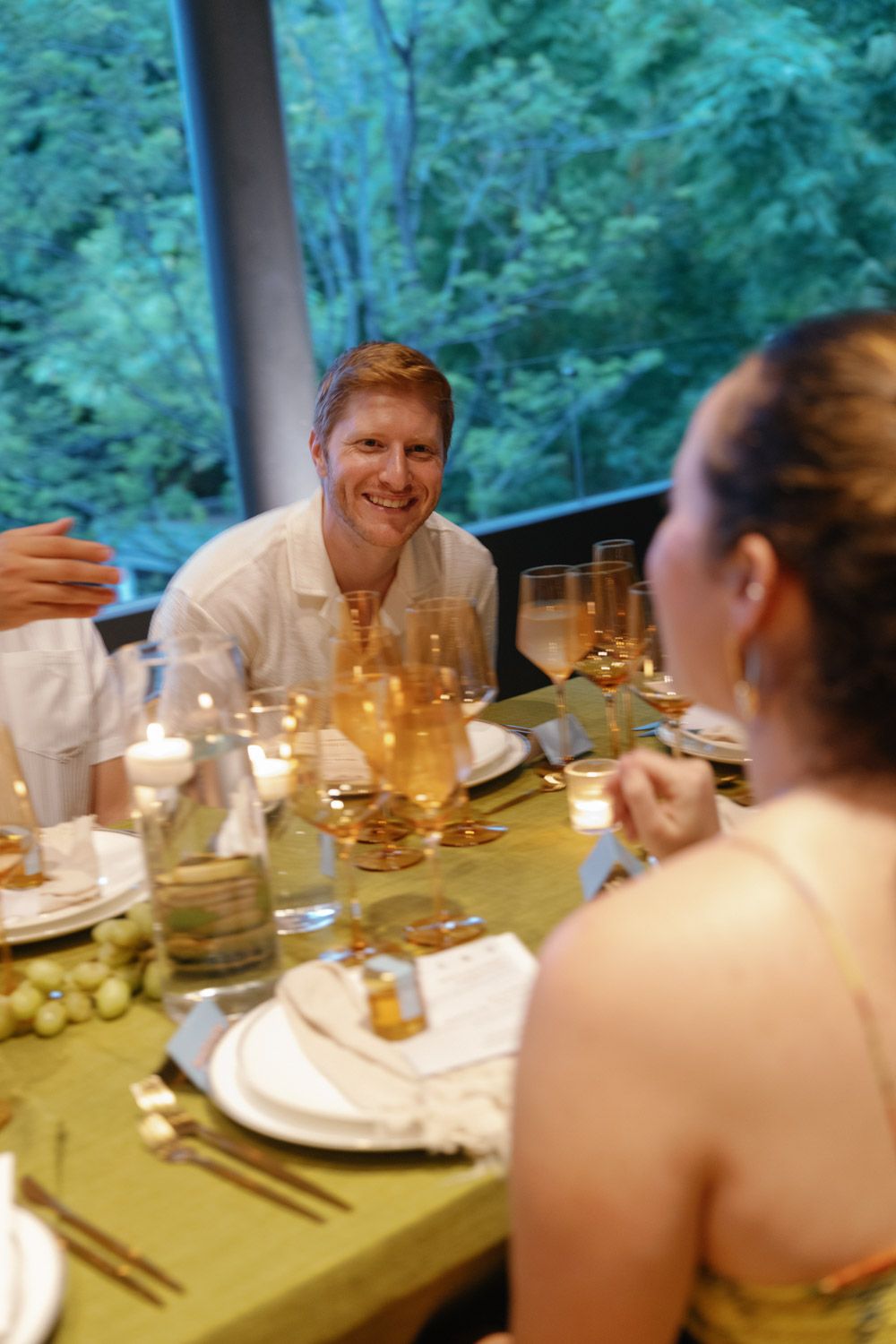 Wedding guests enjoying dinner and conversation at a terrace reception