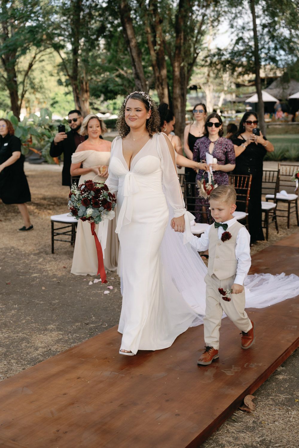 Bride and her son walking down the asile during her El Mangroove beach wedding