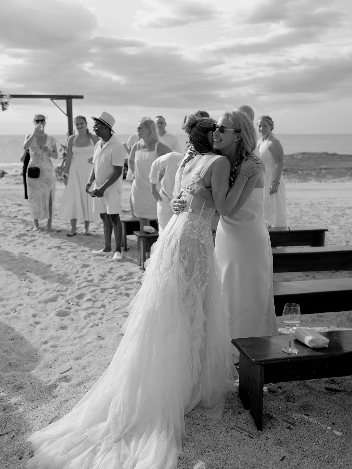 Bride hugs a loved one during a beach ceremony in costa rica