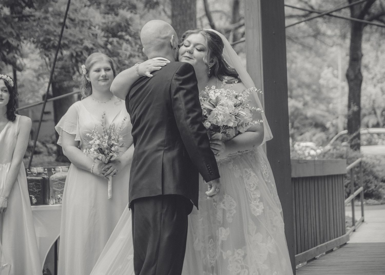 Beautiful black and white photo of father giving away and hugging the bride