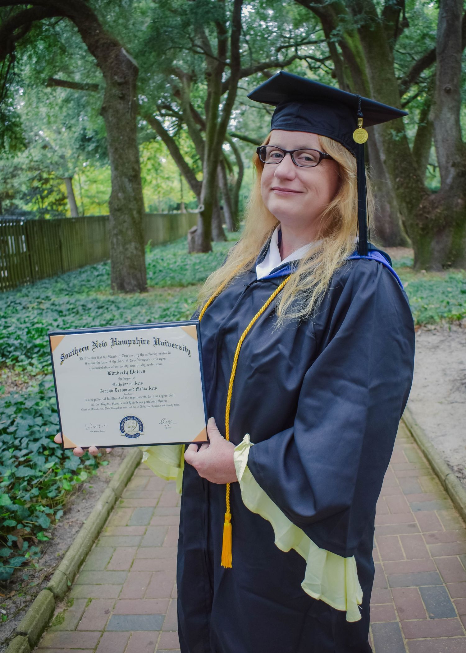 Outdoor natural light photo of college graduate