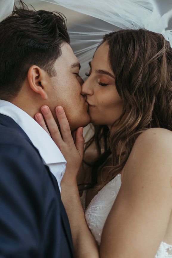 An intimate wedding couple sharing a tender kiss after their wedding in Chander Arizona