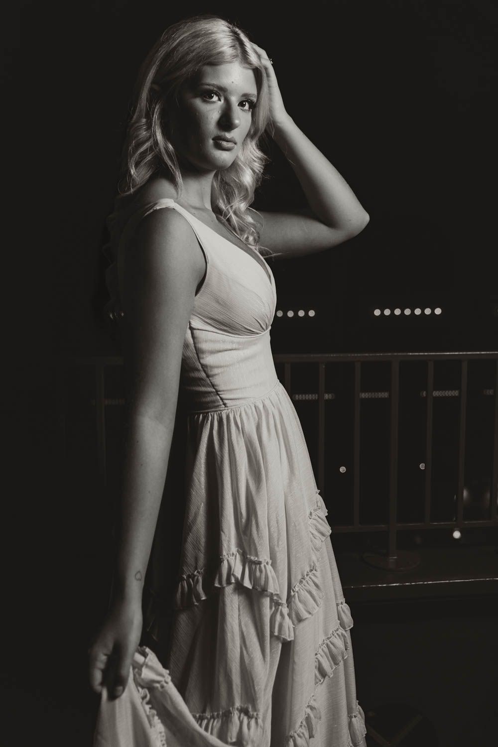 A series of dramatic black and white portraits featuring a woman in a light summer dress against a dark background.