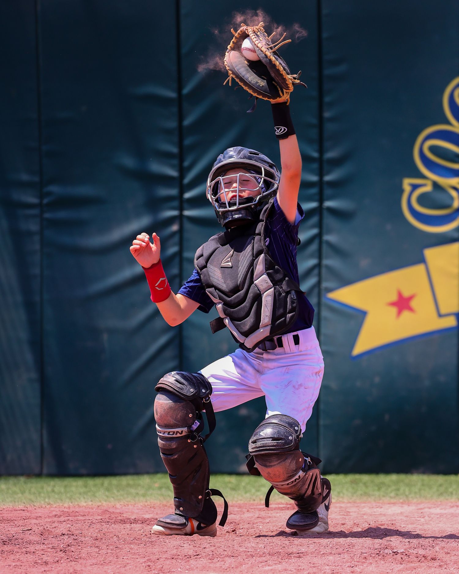 A sequence of four baseball catcher stances showing defensive positioning behind home plate.
